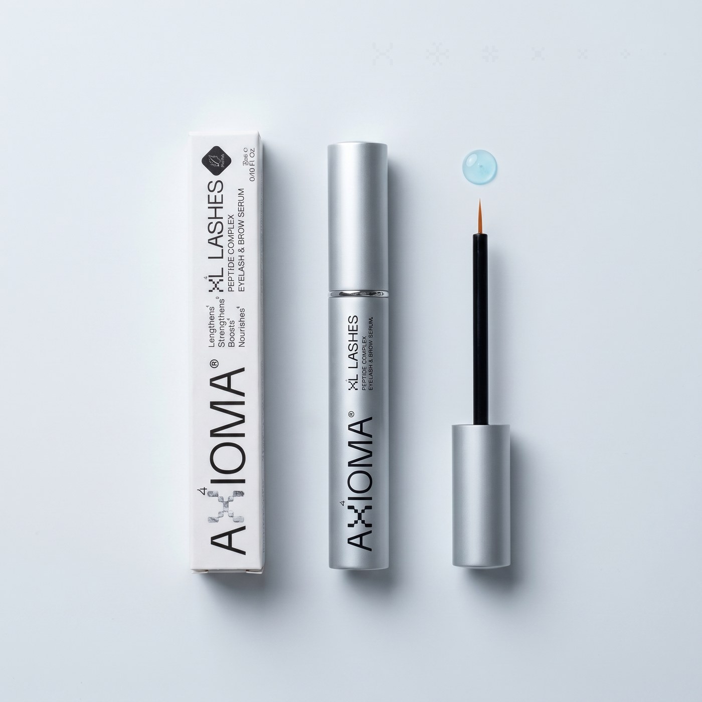 Kit XL Lashes de AXIOMA — caja, frasco y aplicador sobre fondo frío